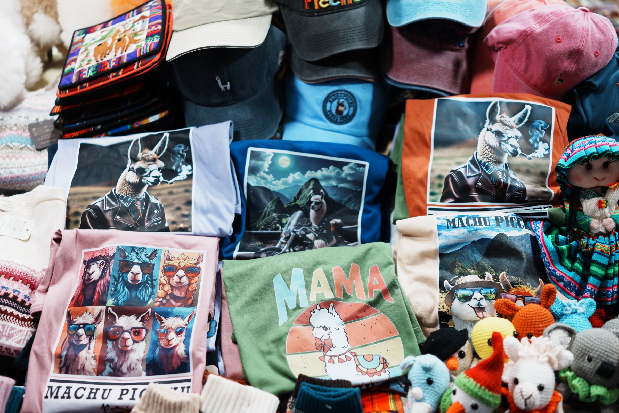T-shirts showing llamas in fantastical scenes near Machu Picchu