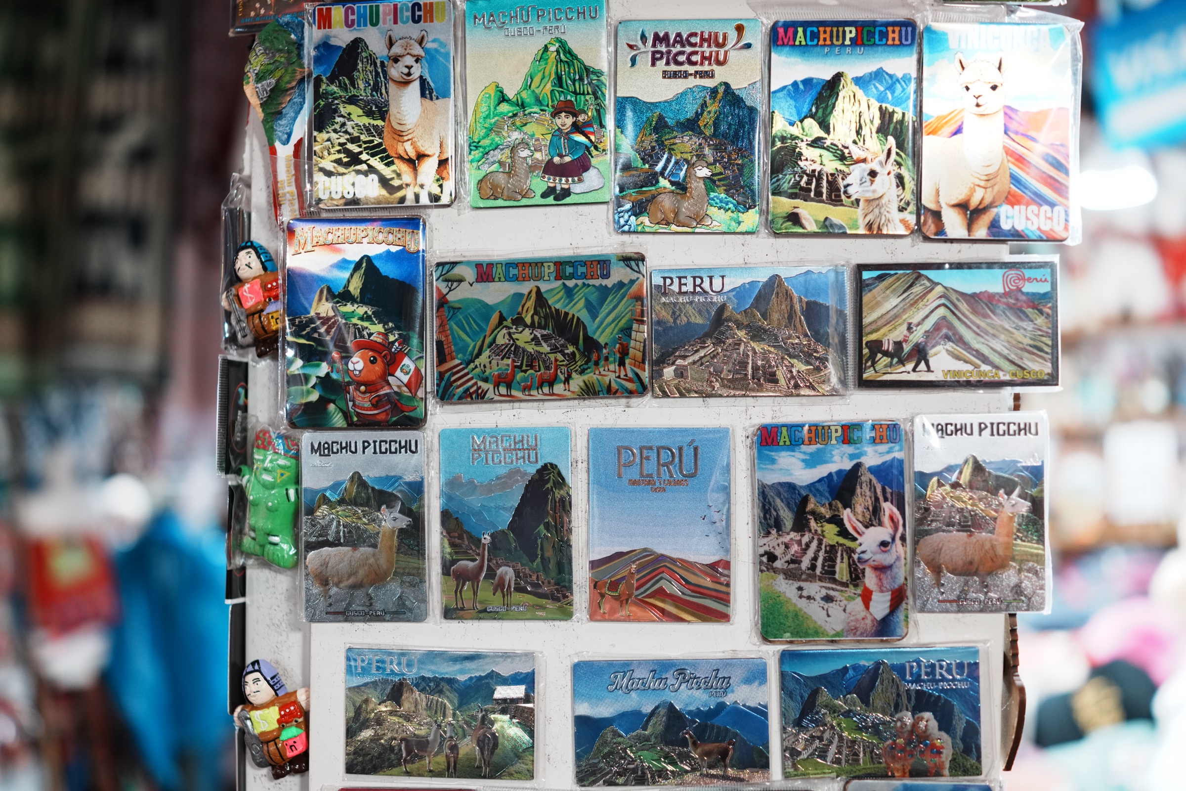 Souvenir magnets combining Machu Picchu, llamas, and familiar Peruvian tourism imagery